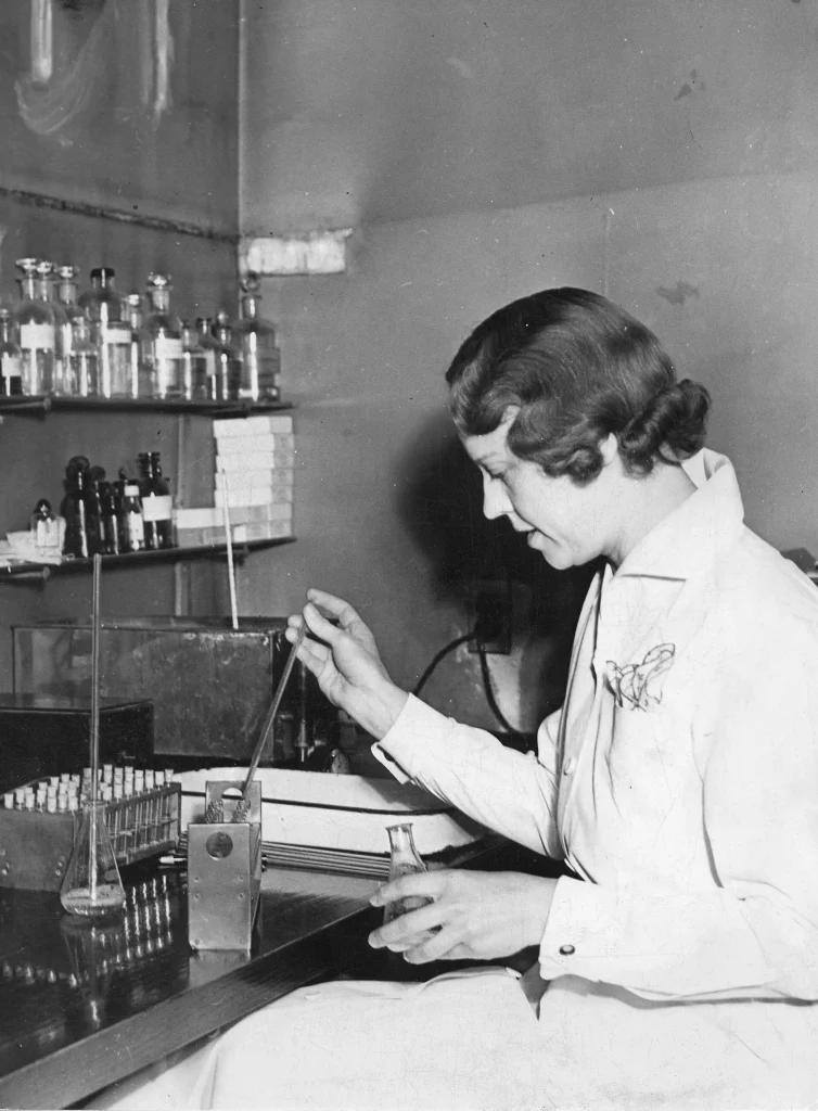 When Disease Tracking Stalls, Your Community Feels It First Laboratory staff member filling test tubes in a public health laboratory