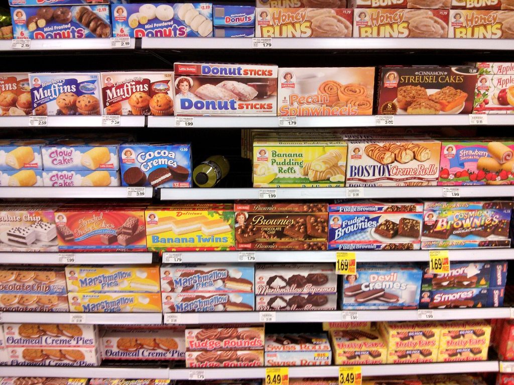 Why Grocery Prices Still Feel Stuck, and What Shoppers Are Doing About It A shopper browsing supermarket shelves