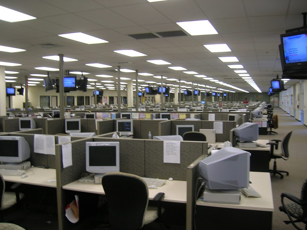 Customer Support Preparation Call centre floor with rows of support workstations and monitors